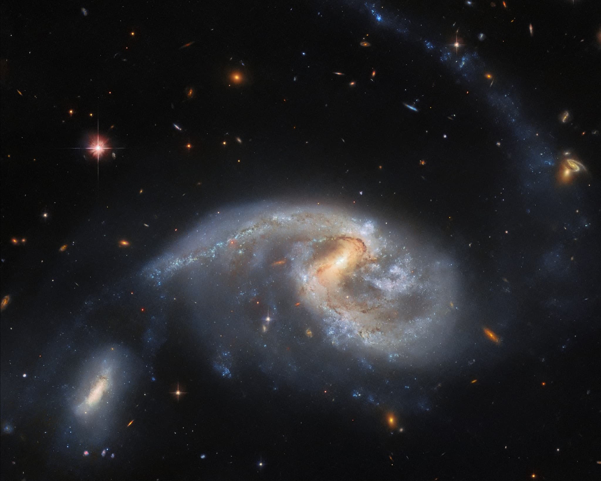 The large spiral galaxy NGC 5996 and its smaller companion NGC 5994, together Arp 72, interacting closely as their gravity draws out a faint tidal tail of stars and gas.