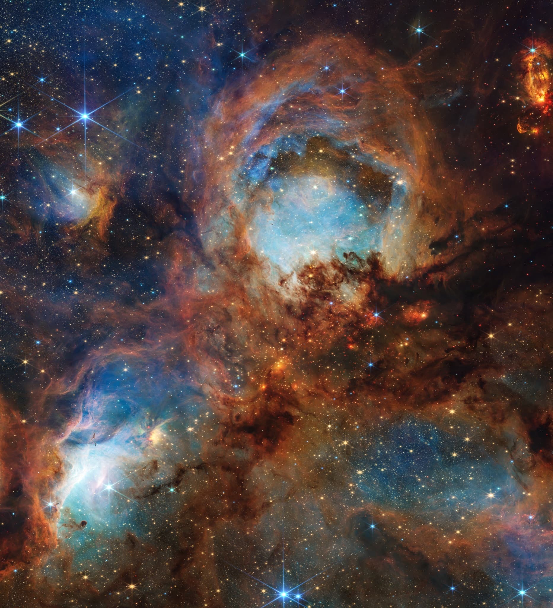Webb close-up of the Cat's Paw Nebula with dense, sculpted clouds of gas.