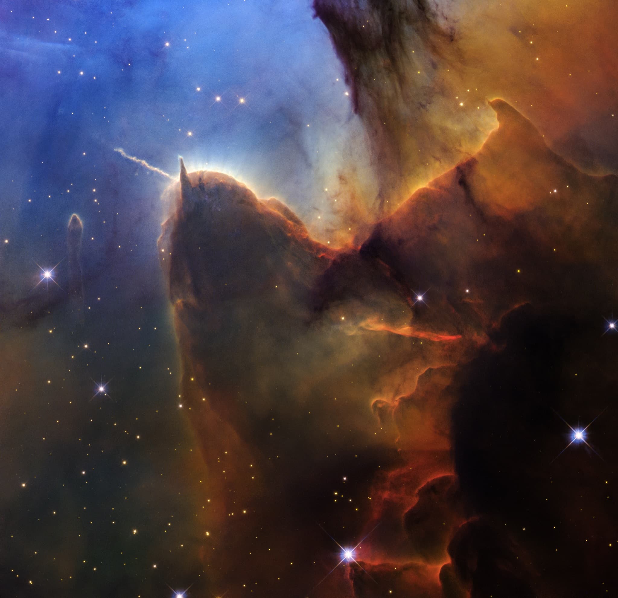 Hubble visible-light close-up of the Trifid Nebula with young stars and dark dust.