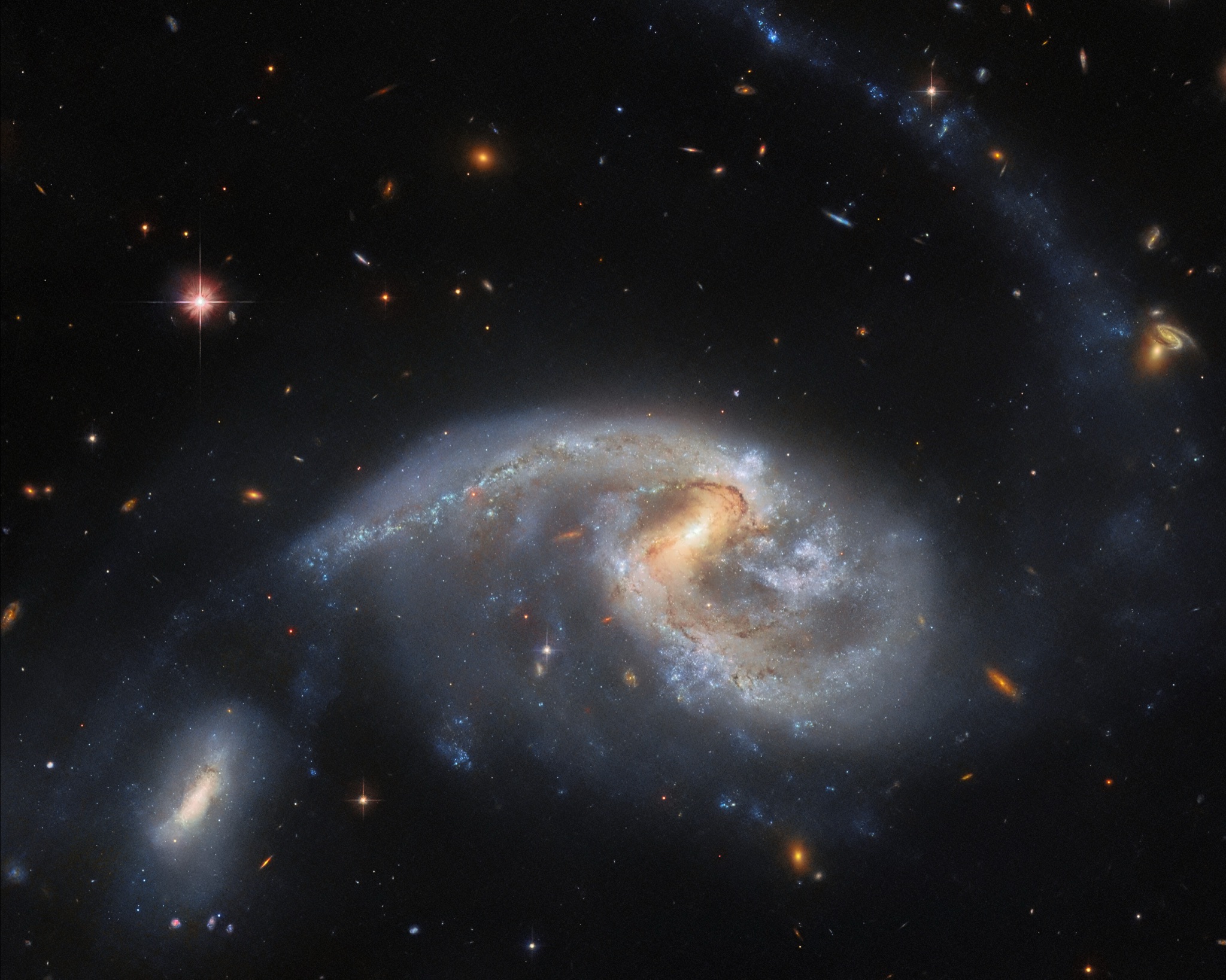 The large spiral galaxy NGC 5996 and its smaller companion NGC 5994, together Arp 72, interacting closely as their gravity draws out a faint tidal tail of stars and gas.
