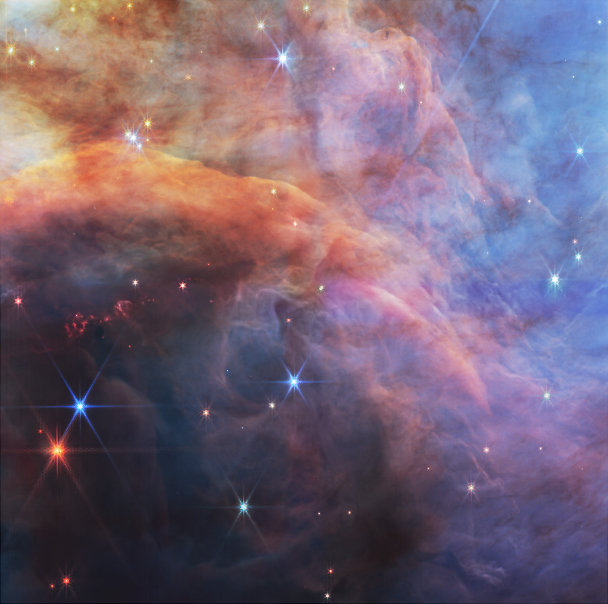 Webb near-infrared view of the Flame Nebula, glowing dust columns against deep space.